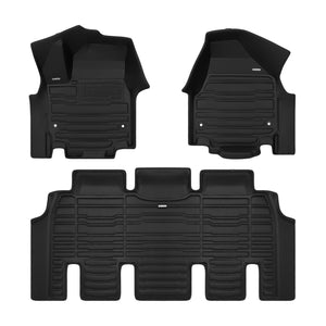 A set of black TuxMat car floor mats for Chrysler Grand Caravan models.